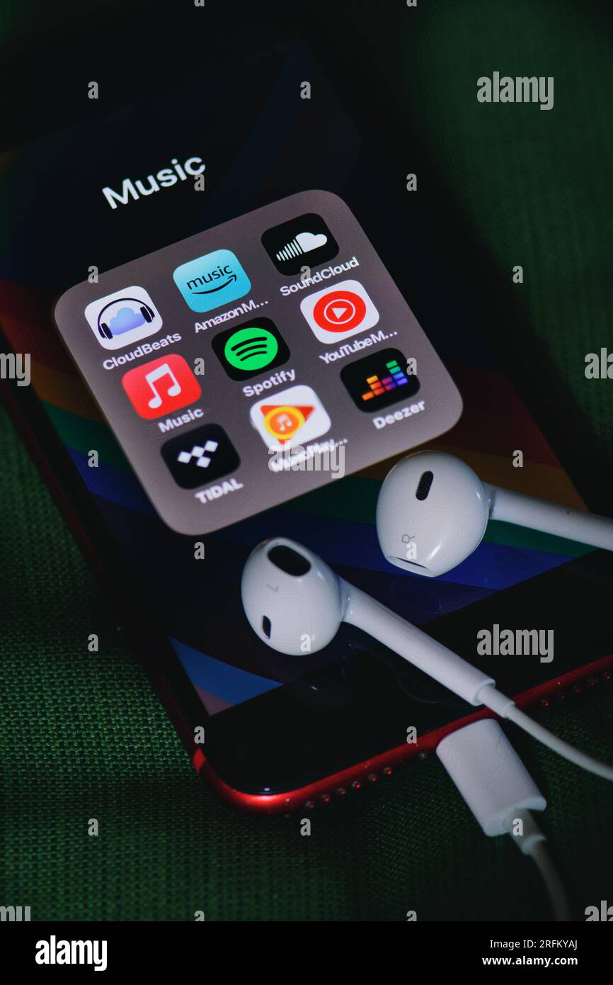 Headsets on smart phone with service icons for listening to music Stock