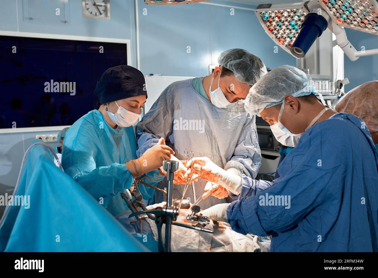 Surgeons team during complex surgical operation in a sterile operating ...