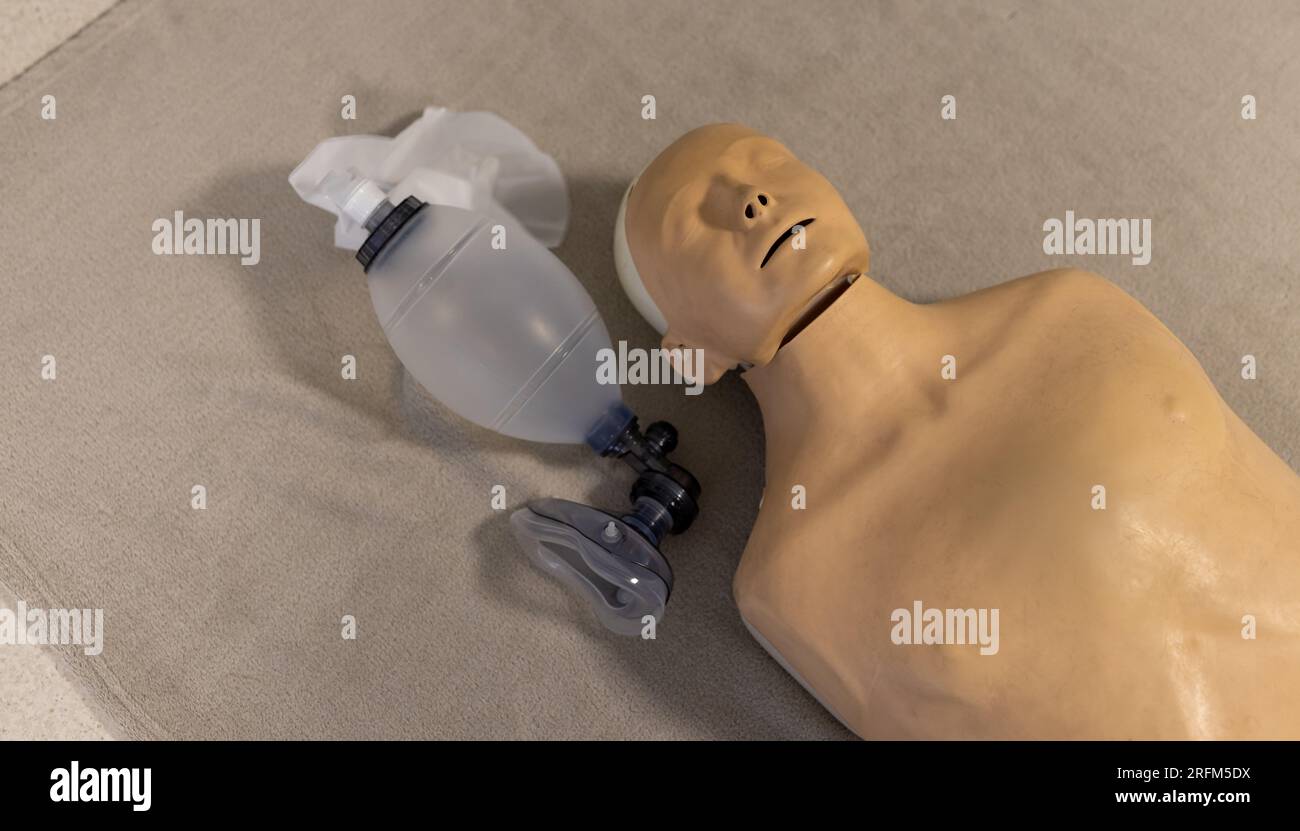 Close up of trainee phantom and oxygen mask on floor at hospital Stock Photo