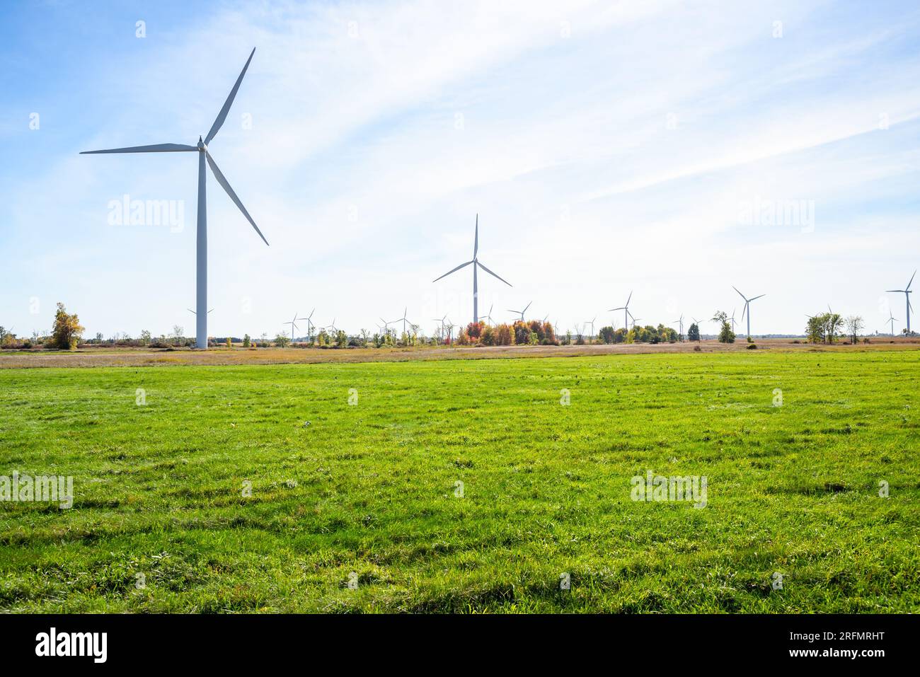 Wind turbines in a rural landscape on a partly cloudy autumn day Stock Photo