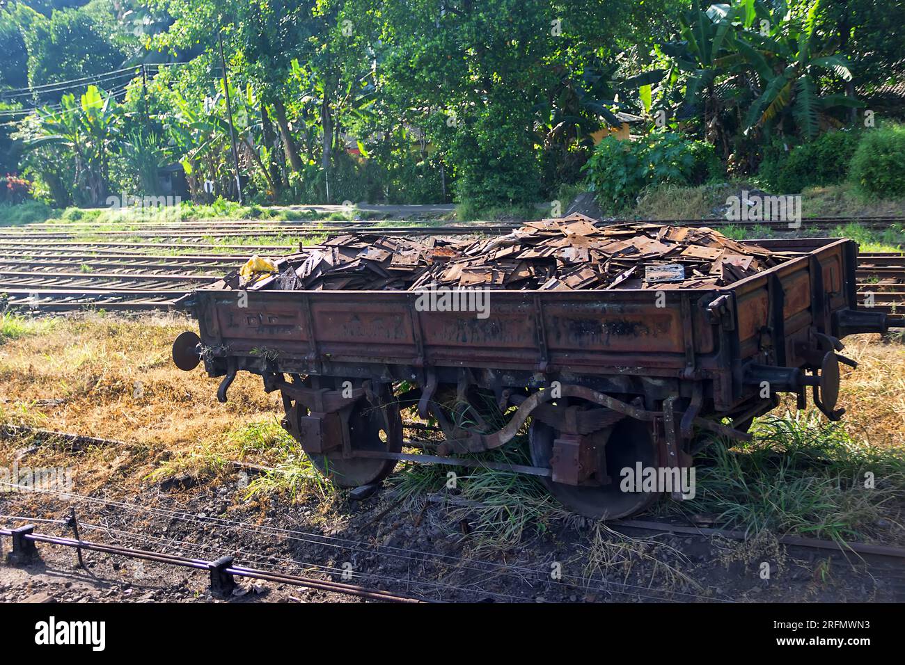 Old railway carriage (platform) with rail bearing plate, rail base. Laying train tracks. Southeast Asia Stock Photo