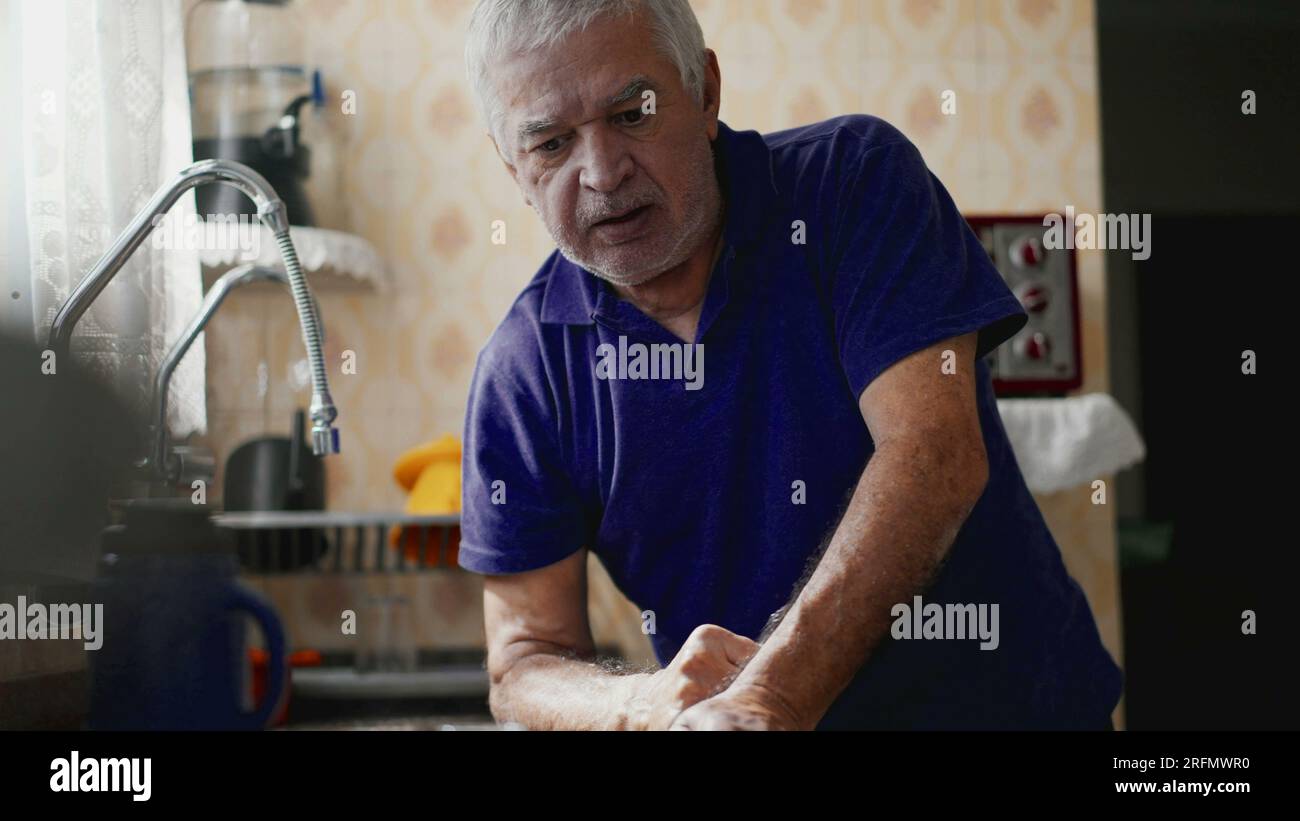 Sickly Anxious Senior Person Alone at Home, Overcome with Sorrow. Despairing Elderly Man at Home, Suffering chronic disease Stock Photo