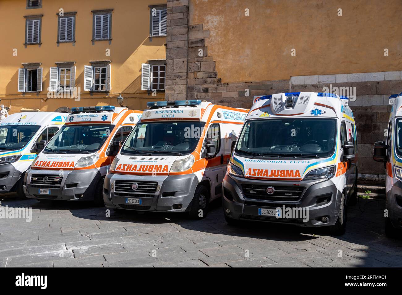 A fleet of parked ambulances in the city of Lucca in the Tuscany region of Italy. Stock Photo