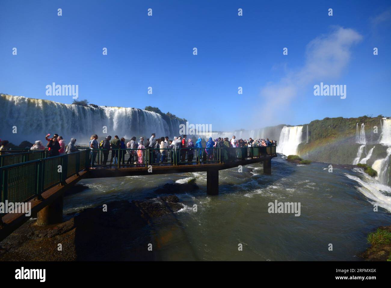 Tourists at Iguazu Falls, one of the great natural wonders of the world, on the border of Brazil and Argentina Stock Photo