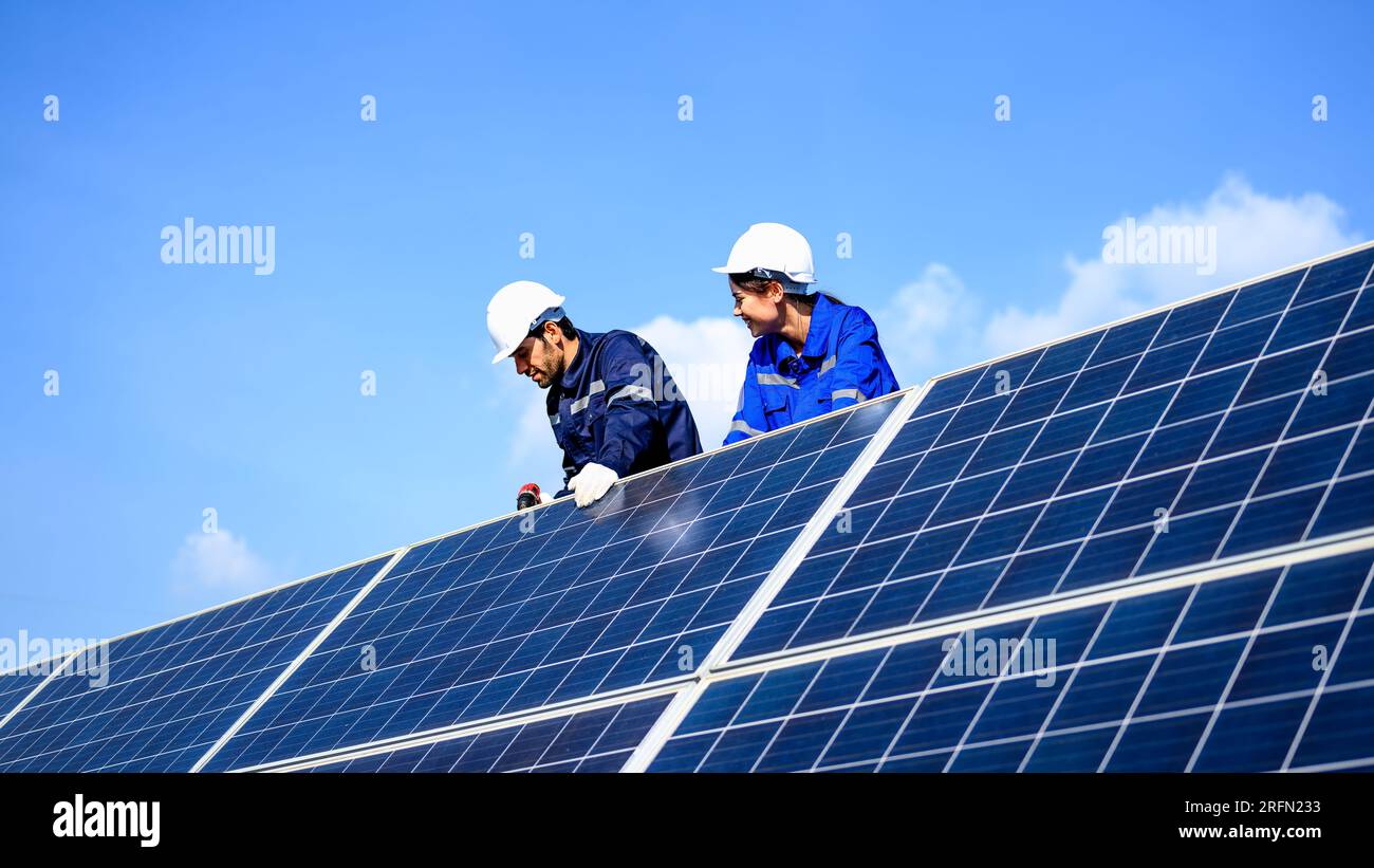 Technicians workers installing solar panels at solar cell farm Stock ...