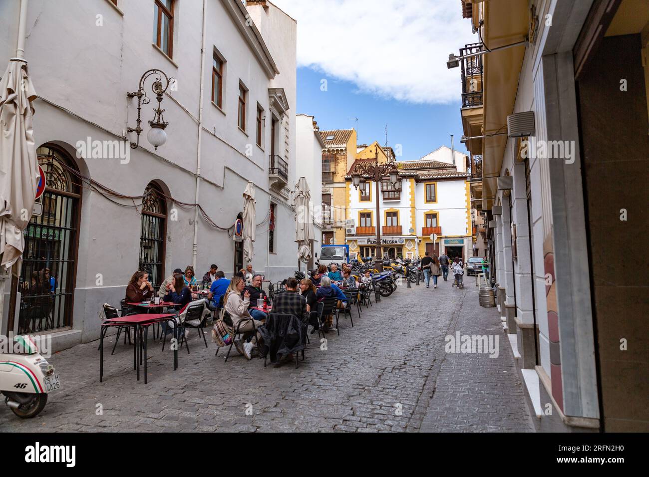 Granada, Spain - February 23, 2022: Generic architecture and street view with cafes and stores in the historical city of Granada in Andalusia, Spain. Stock Photo