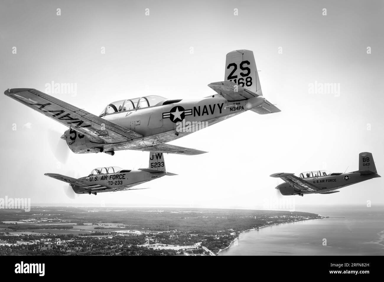 A formation of three Beechcraft T-34 Mentors descend over Lake Michigan in to Manitowoc, Wisconsin. Stock Photo
