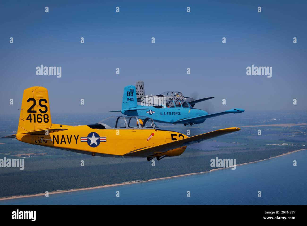Three Beechcraft T-34 Mentors in formation over Lake Michigan at Point ...