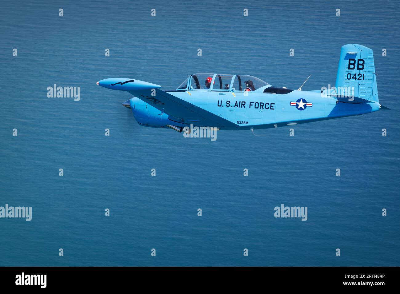 A Beechcraft T-34 Mentor flying over Lake Michigan off the coast of Manitowoc, Wisconsin. Stock Photo