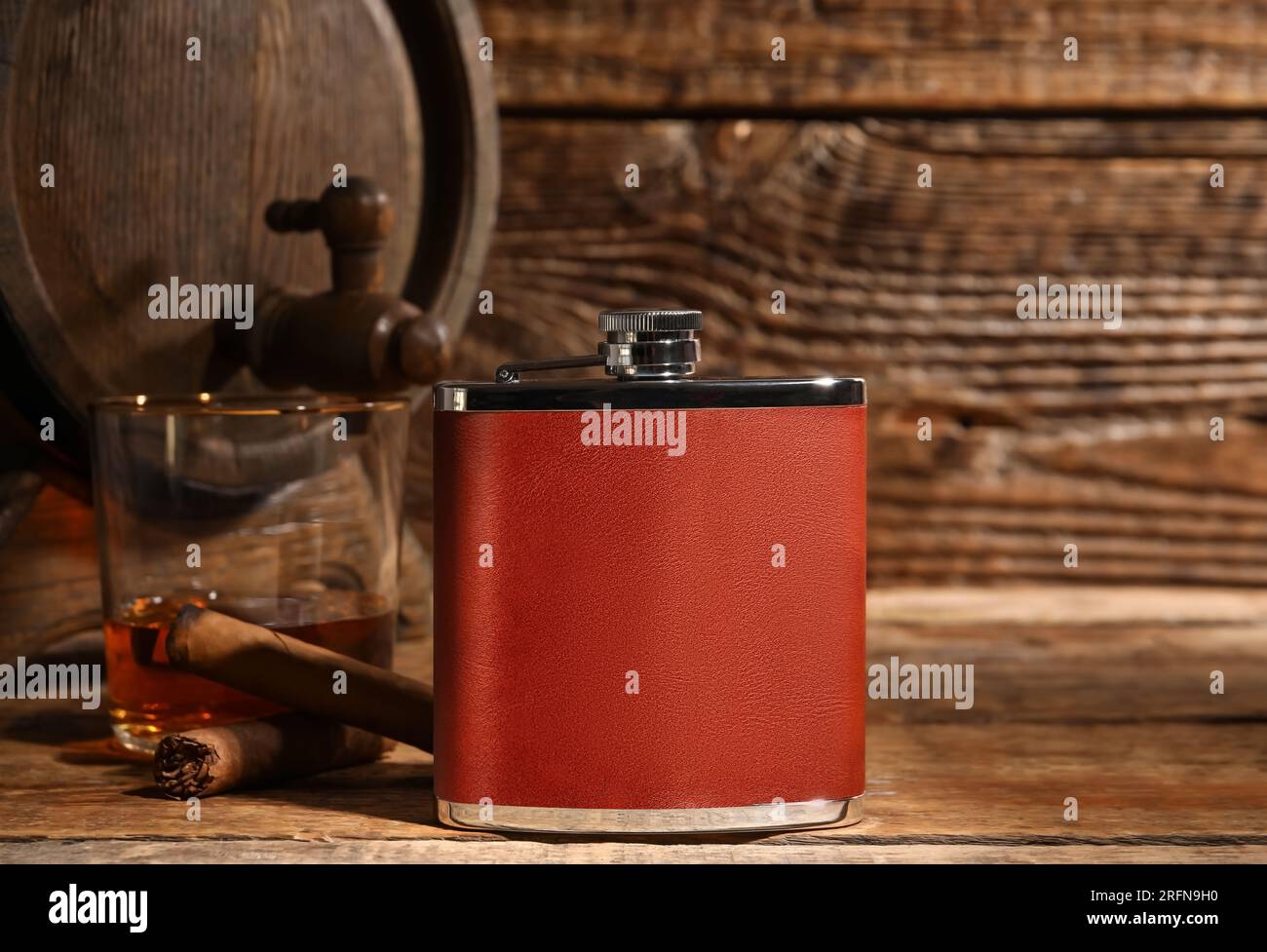 New hip flask on wooden background Stock Photo