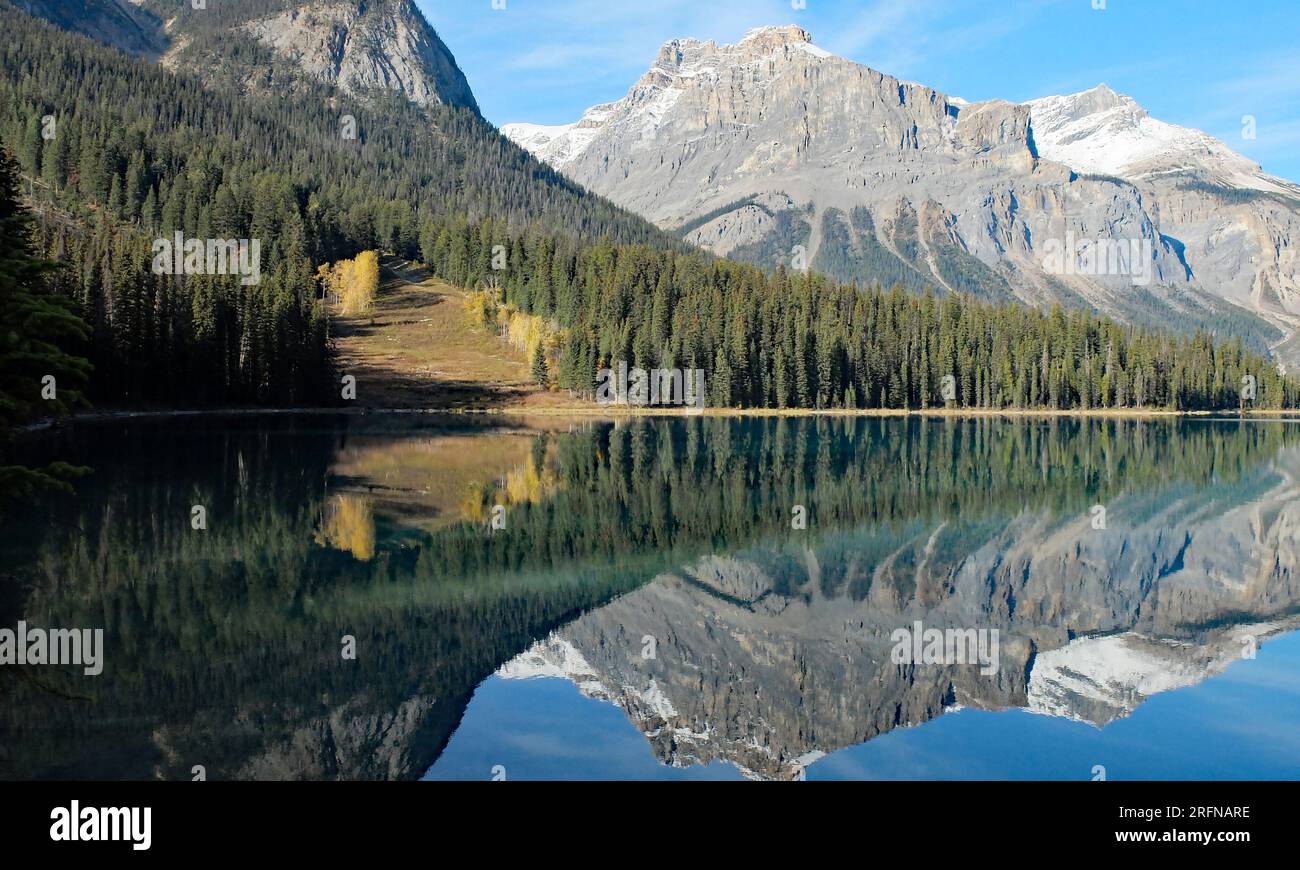 The reflection of the Rocky Mountains in a blue lake called Emerald Lake Stock Photo