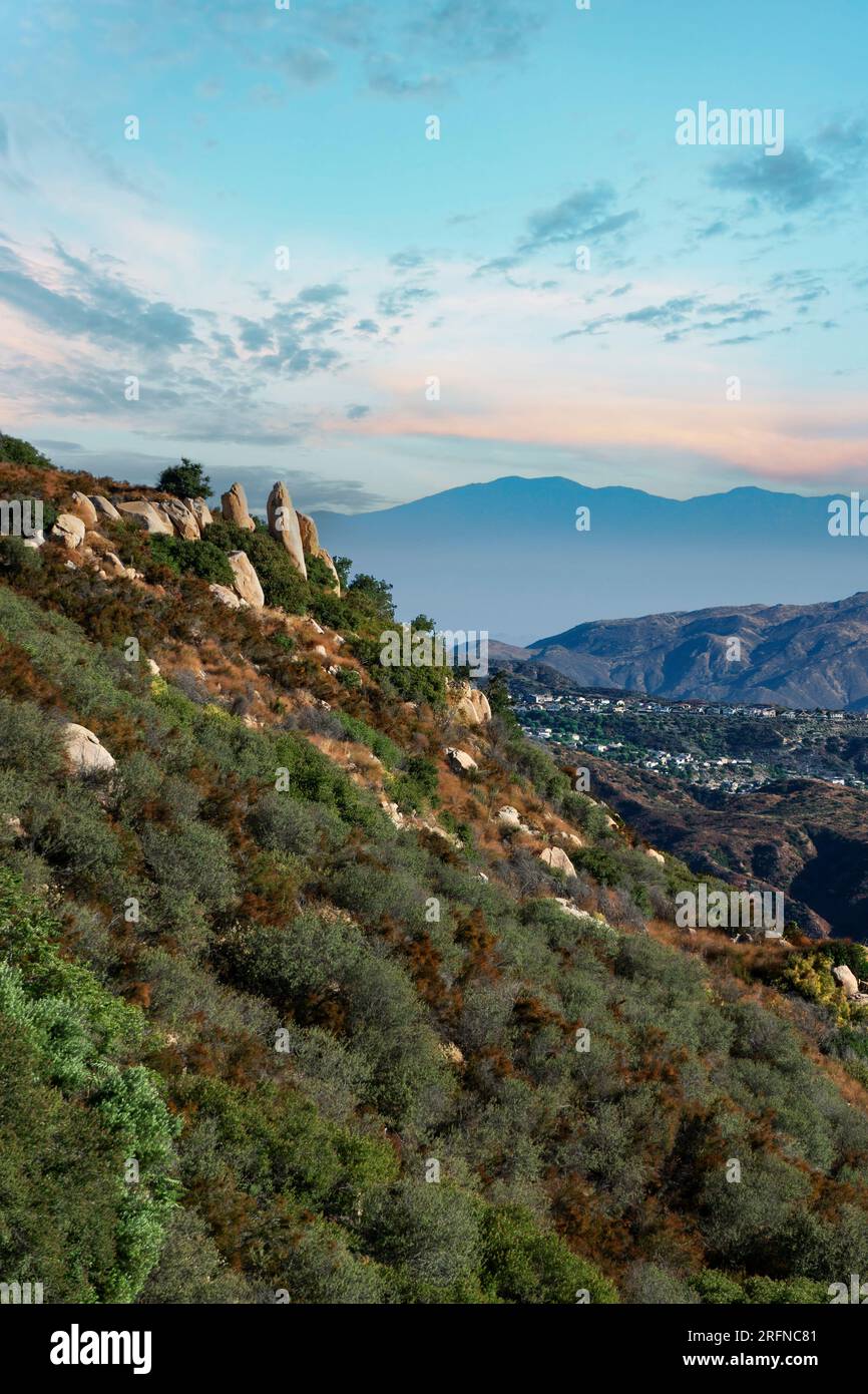 View of a rocky mountain side over Lake Elsinore, California in the morning. Stock Photo