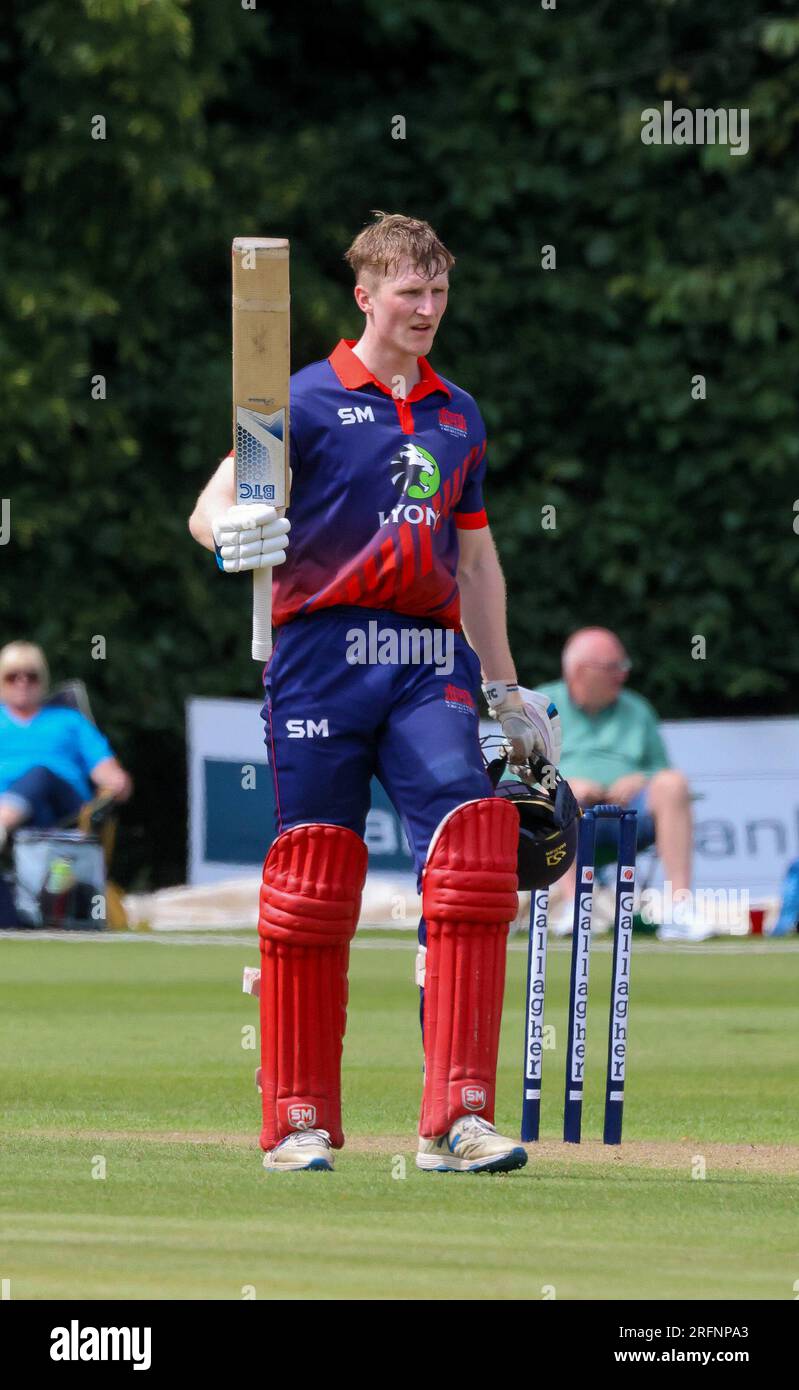 Stormont, Belfast, Northern Ireland, UK. 04 Aug 2023. The Gallagher Challenge Cup Final – Carrickfergus v Waringstown (red). Waringstown won the final by 36 runs. Waringstown 354-4 Carrickfergus 318. Morgan Topping reaches 100.  Credit: David Hunter/Alamy Live New Stock Photo