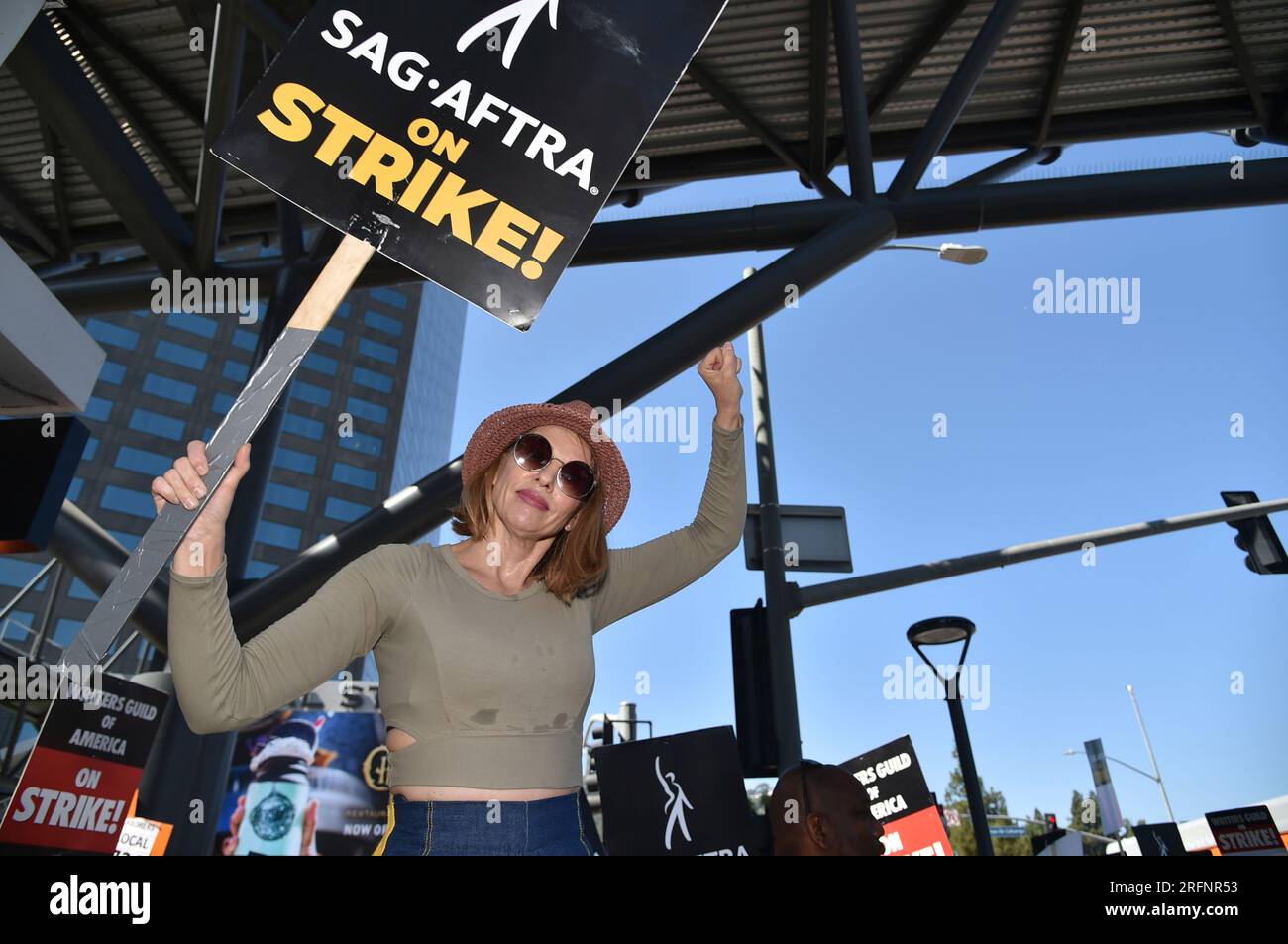 Picketers carry signs on the picket line outside Universal Studios on ...