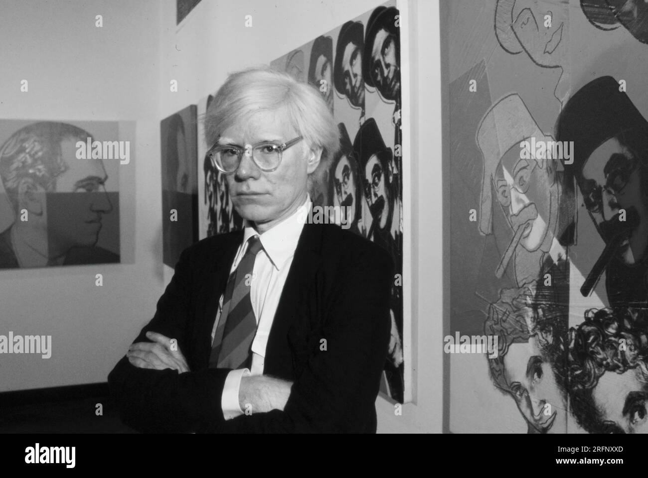 Andy Warhol in a NY gallery with his art portraits in 1975. Warhol was