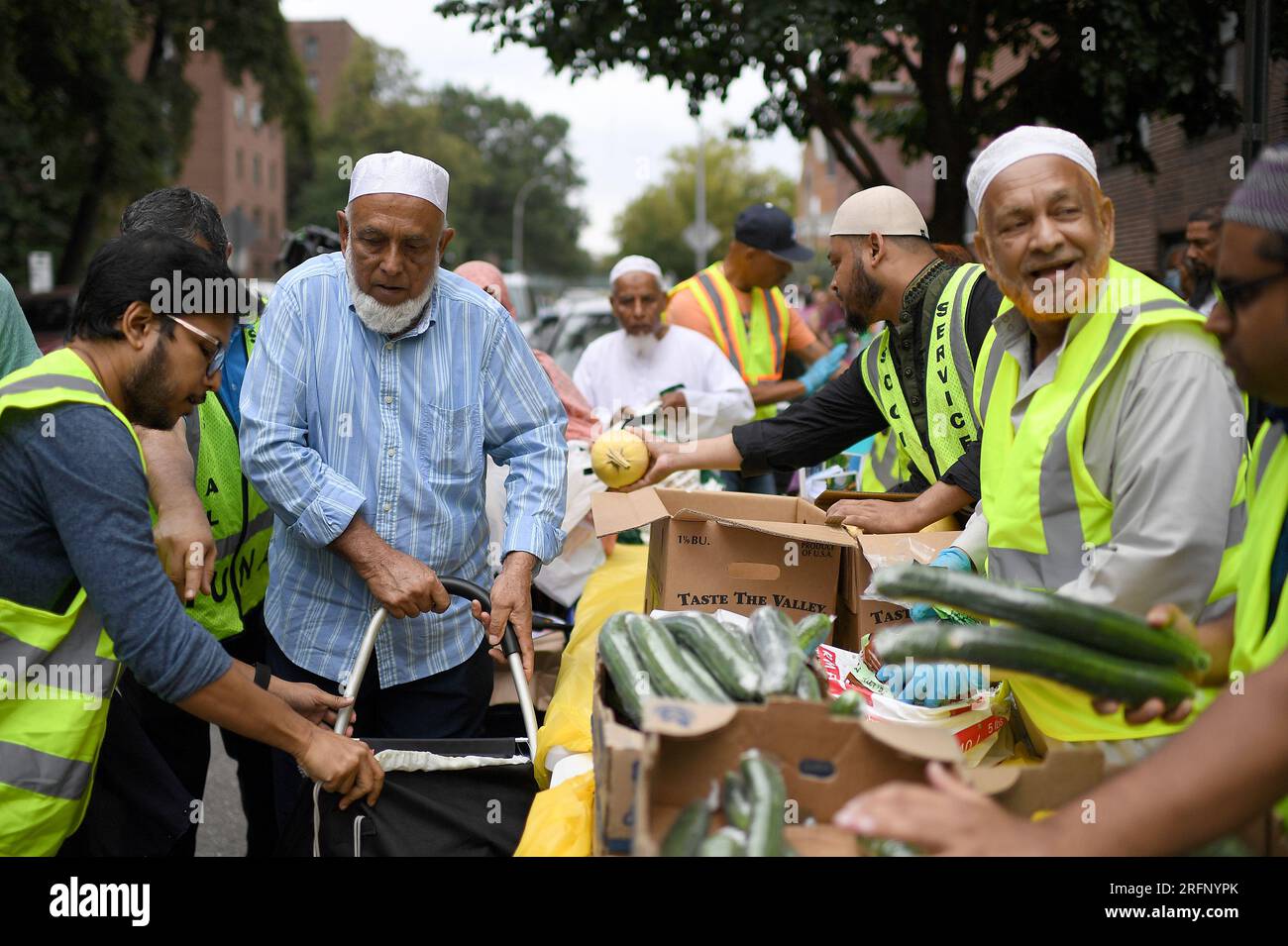 New York, USA. 04th Aug, 2023. People receive donated ‘halal' food outside the Parkchester