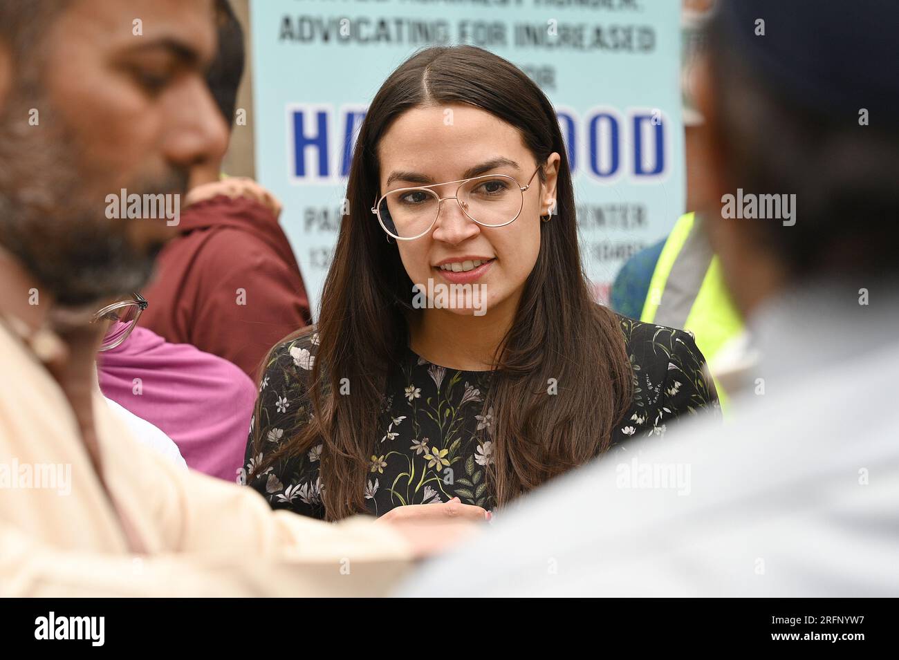 New York, USA. 04th Aug, 2023. Rep. Alexandria Ocasio-Cortez helps distribute food to people suffering from food insecurities at the Parkchester Islamic Center in the New York City borough of the Bronx, NY, August 4, 2023. Rep. Ocasio-Cortez outlined her efforts to increase access to halal and kosher food in the 2023 federal ‘Farm bill', as Muslim and Jewish families struggle to afford food that meets their faith's dietary guidelines. (Photo by Anthony Behar/Sipa USA) Credit: Sipa USA/Alamy Live News Stock Photo
