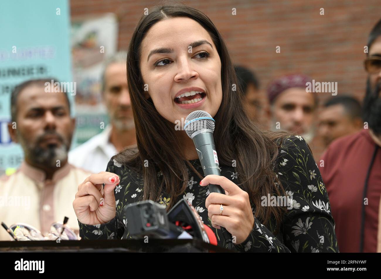 New York, USA. 04th Aug, 2023. Rep. Alexandria Ocasio-Cortez speaks before distributing food to people suffering from food insecurities at the Parkchester Islamic Center in the New York City borough of the Bronx, NY, August 4, 2023. Rep. Ocasio-Cortez outlined her efforts to increase access to halal and kosher food in the 2023 federal ‘Farm bill', as Muslim and Jewish families struggle to afford food that meets their faith's dietary guidelines. (Photo by Anthony Behar/Sipa USA) Credit: Sipa USA/Alamy Live News Stock Photo