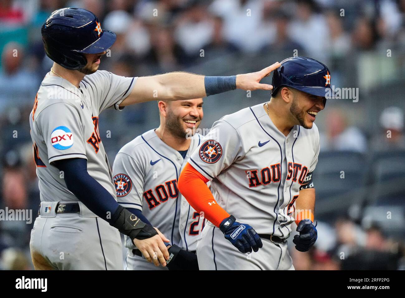Houston Astros' Kyle Tucker, left, celebrates with Jose Altuve, rear ...