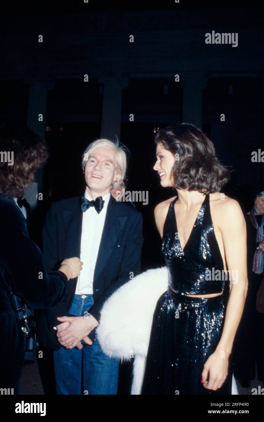 Andy Warhol with unidentified woman in evening gown in 1977. Warhol was