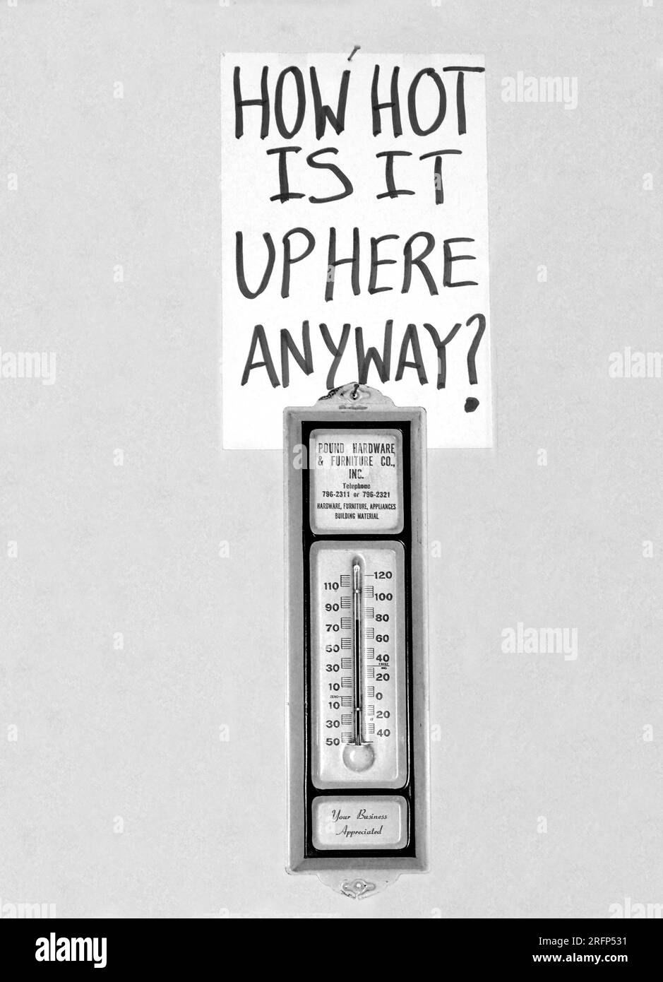 A thermometer on a wall in the non-air conditioned upstairs room of an antique shop in Abingdon, Virginia. Stock Photo