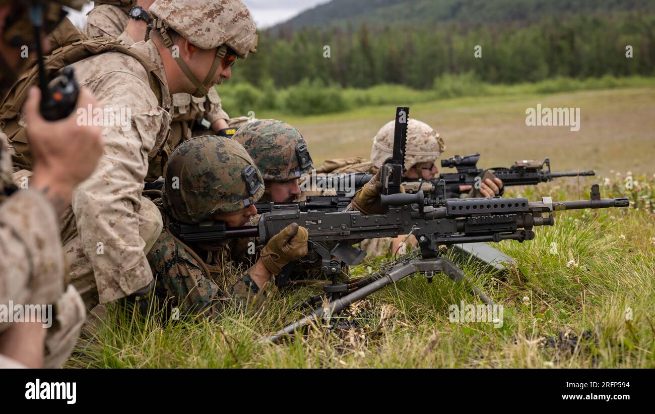 U.S. Marines fire M240B machine guns during the Force Headquarters Group Super Squad Competition at Joint Base Elmendorf-Richardson, Alaska, July, 25, 2023. During the multi-day competition, reserve units from all across the Marine Corps, exercised their technical and tactical proficiencies by competing in events that highlighted offensive/defensive operations, patrolling techniques, combat marksmanship, physical endurance and small unit leadership. (U.S. Marine Corps photo by Cpl. Mitchell Johnson) Stock Photo