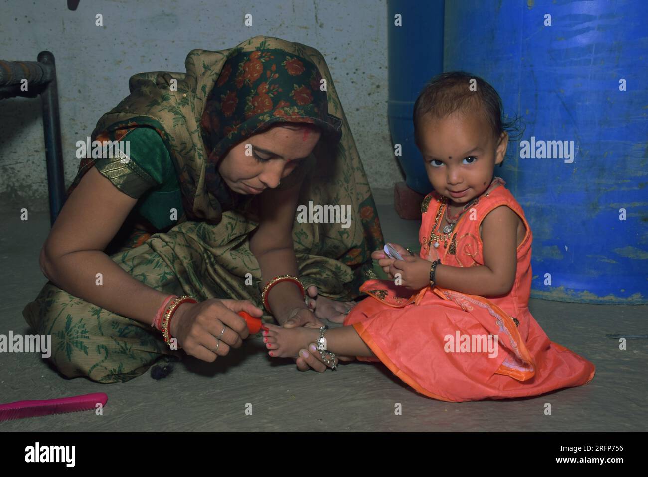 Indian woman holding baby in hi-res stock photography and images - Alamy