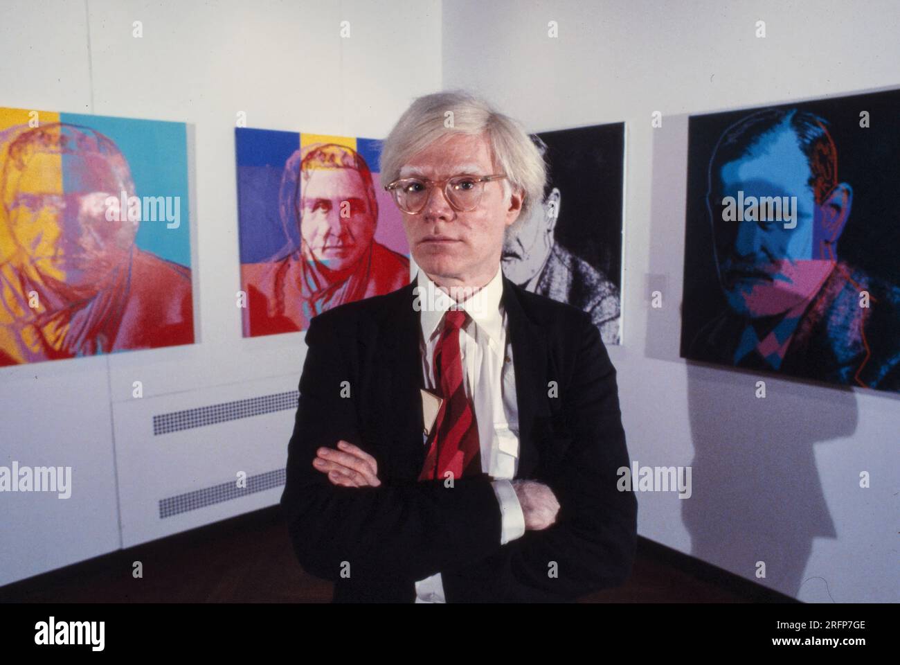 Andy Warhol in a NY gallery with his art portraits in 1975. Warhol was