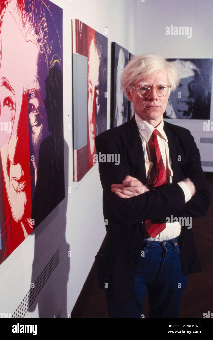 Andy Warhol in a NY gallery with his art portraits in 1975. Warhol was