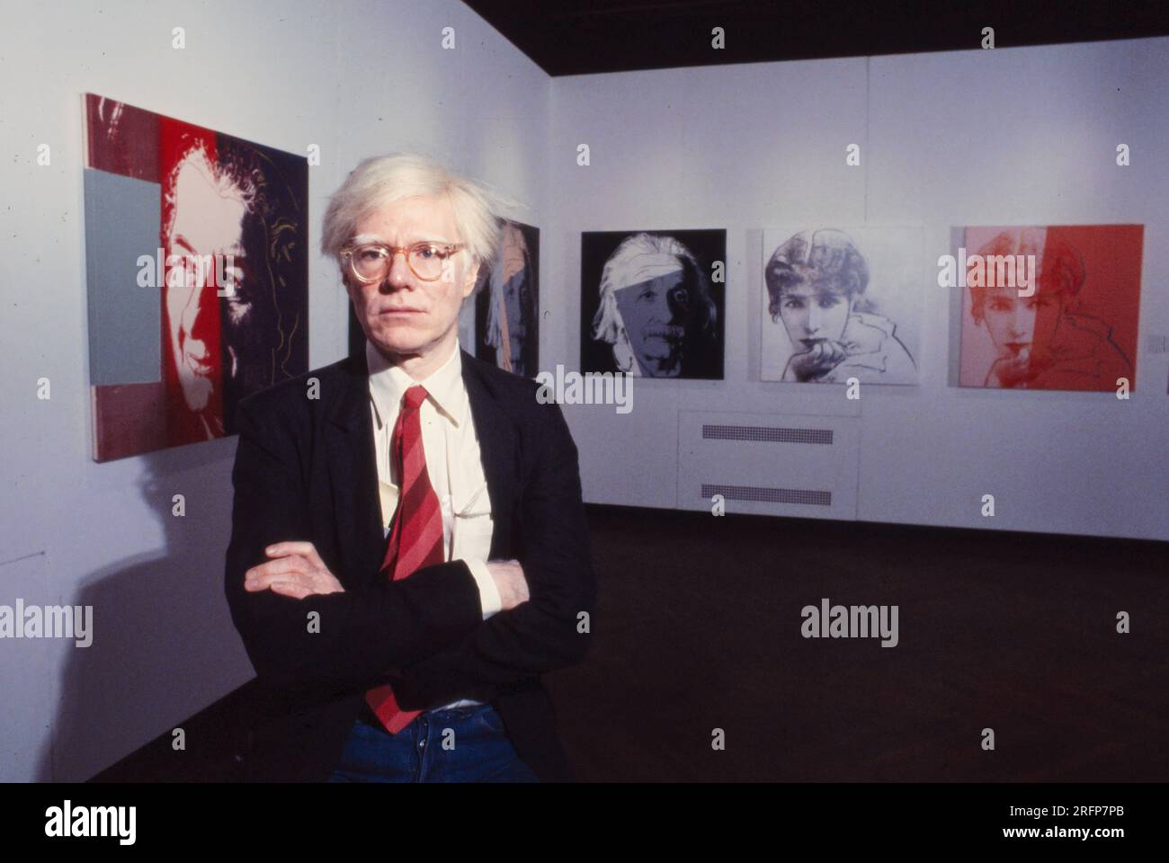 Andy Warhol in a NY gallery with his art portraits in 1975. Warhol was
