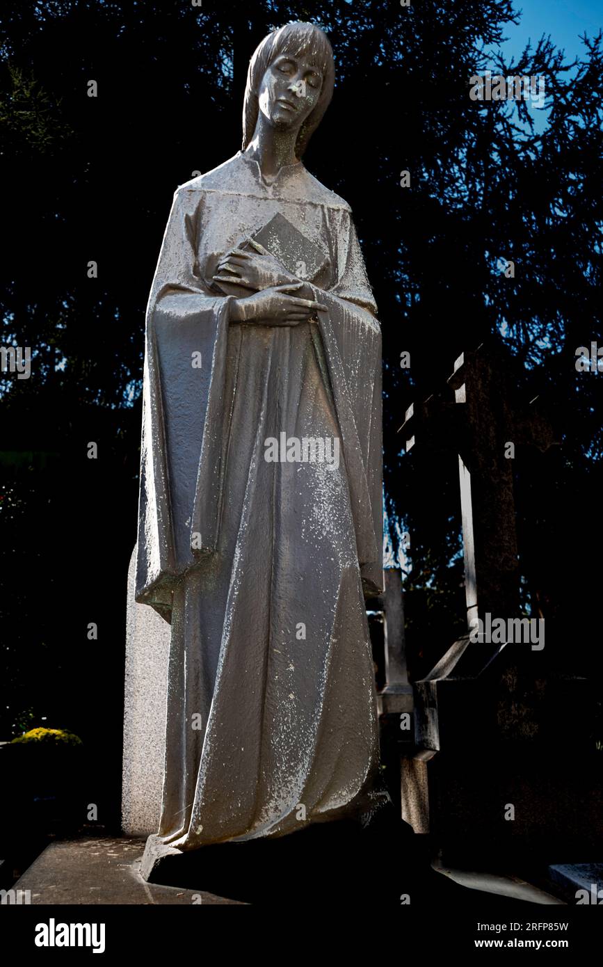 Standing cemetery statue in robes Stock Photo
