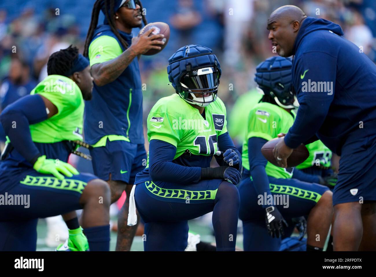 Seattle Seahawks linebacker Uchenna Nwosu (10) stretches before the NFL