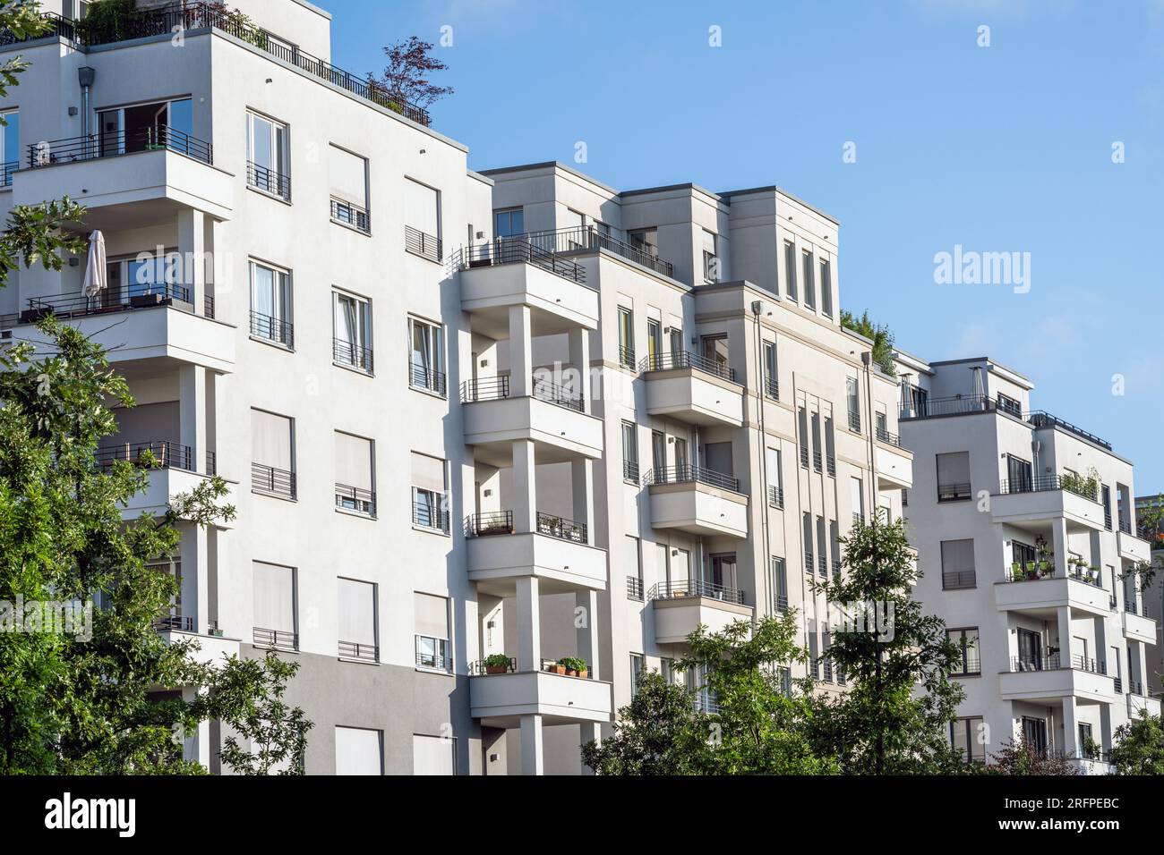 White apartment building with trees seen in Berlin, Germany Stock Photo