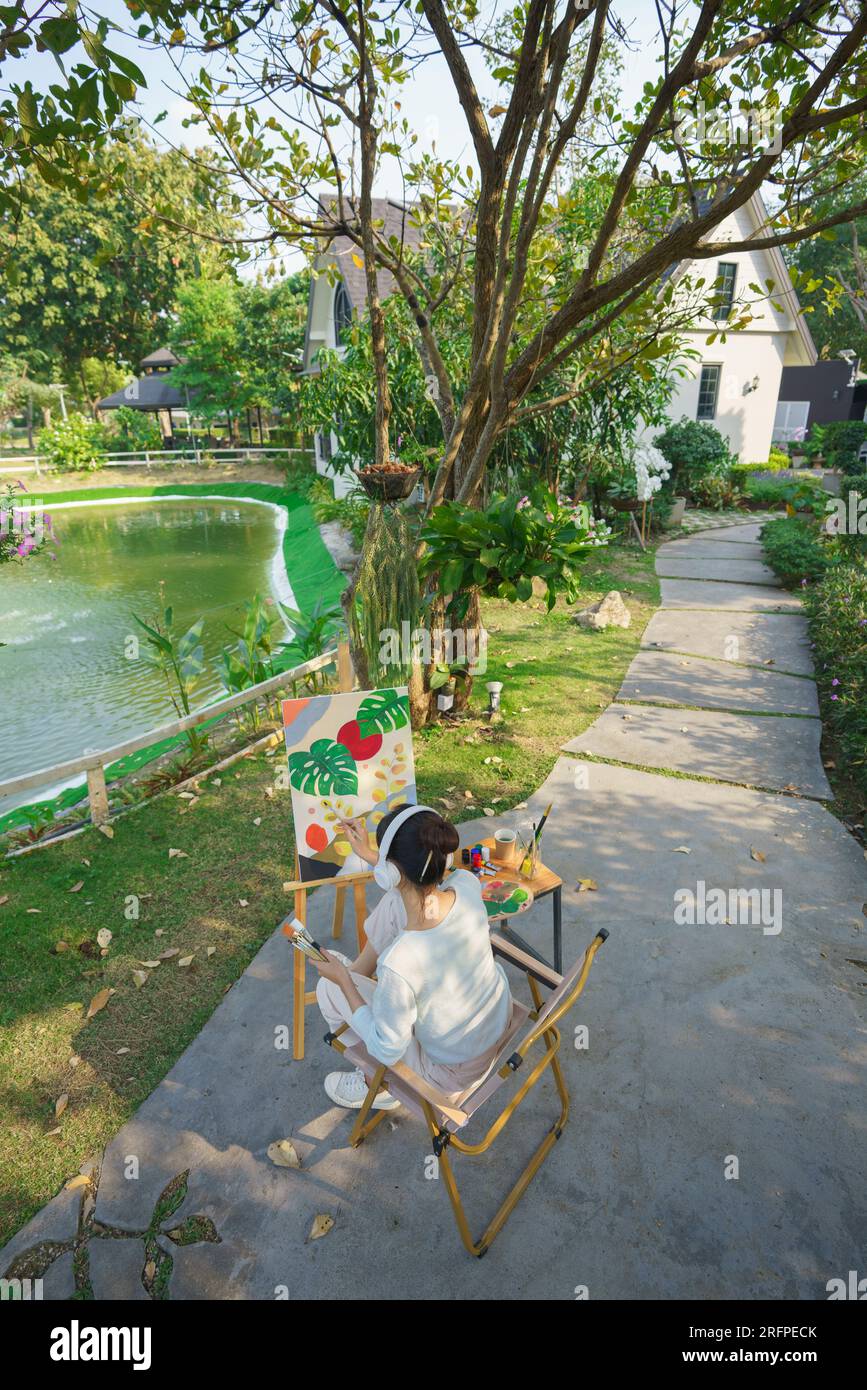 Outdoor activity concept, Female artist wears headphone to listening ...