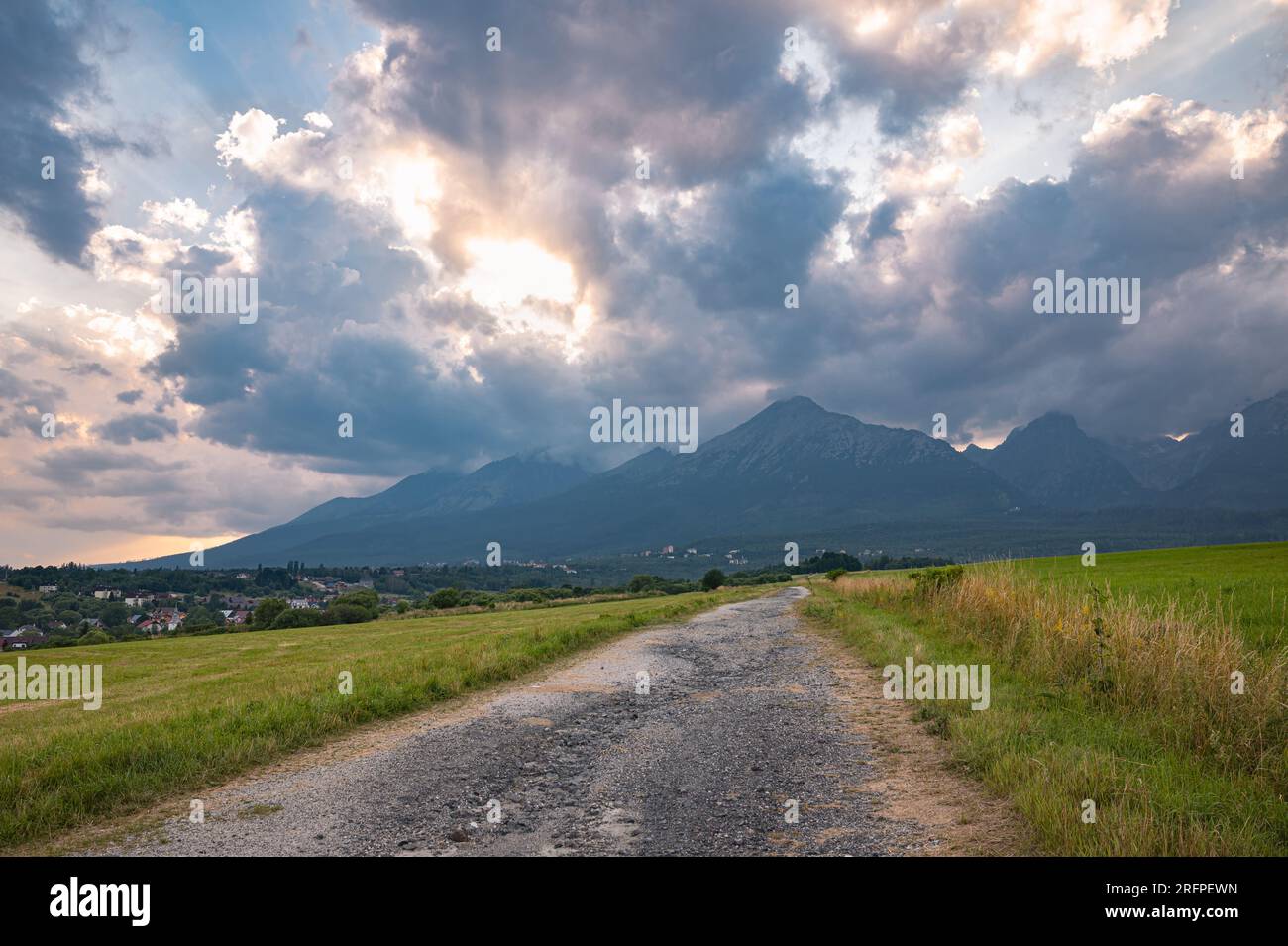 Scenic view of a path leading to the Tatra mountains in Slovakia at sunset. Stock Photo
