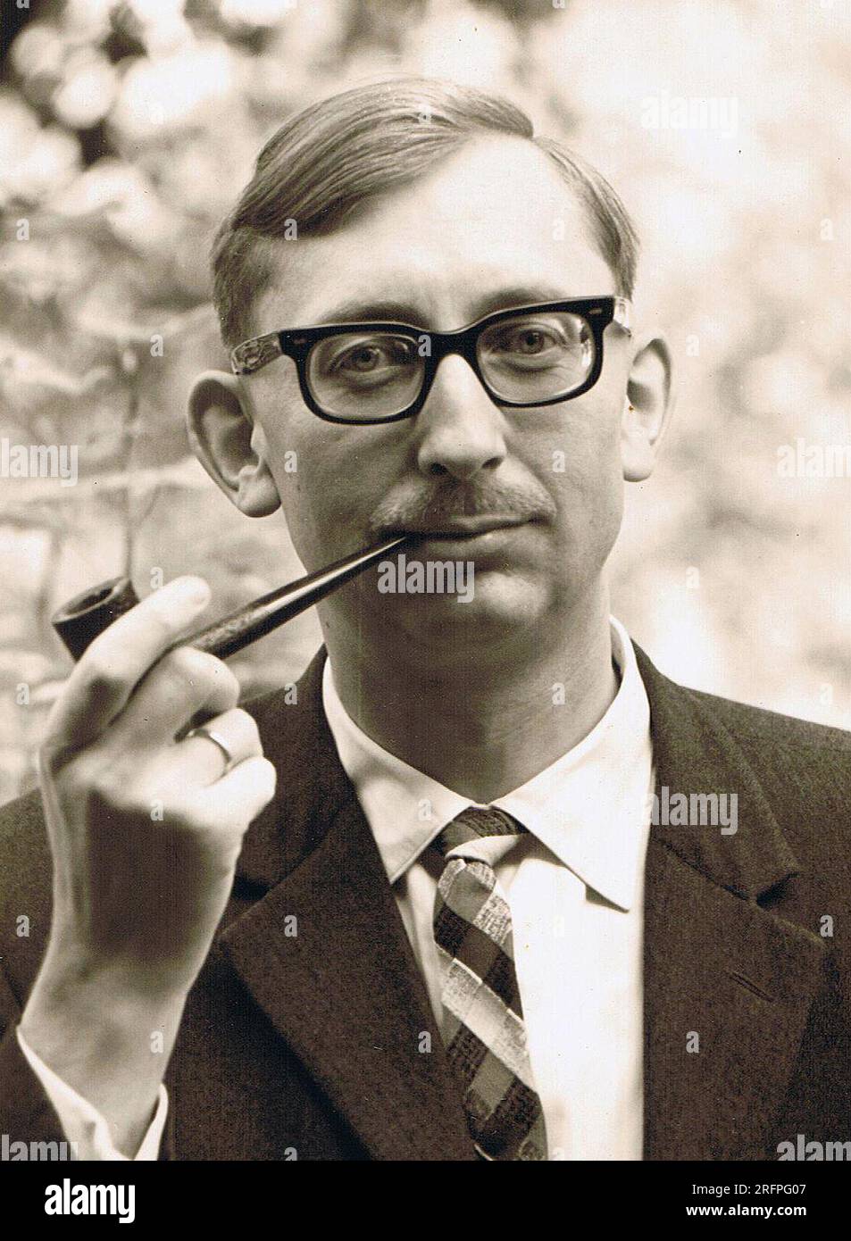 A thirty year old German man smoking a pipe. The photo was taken around 1961 Stock Photo