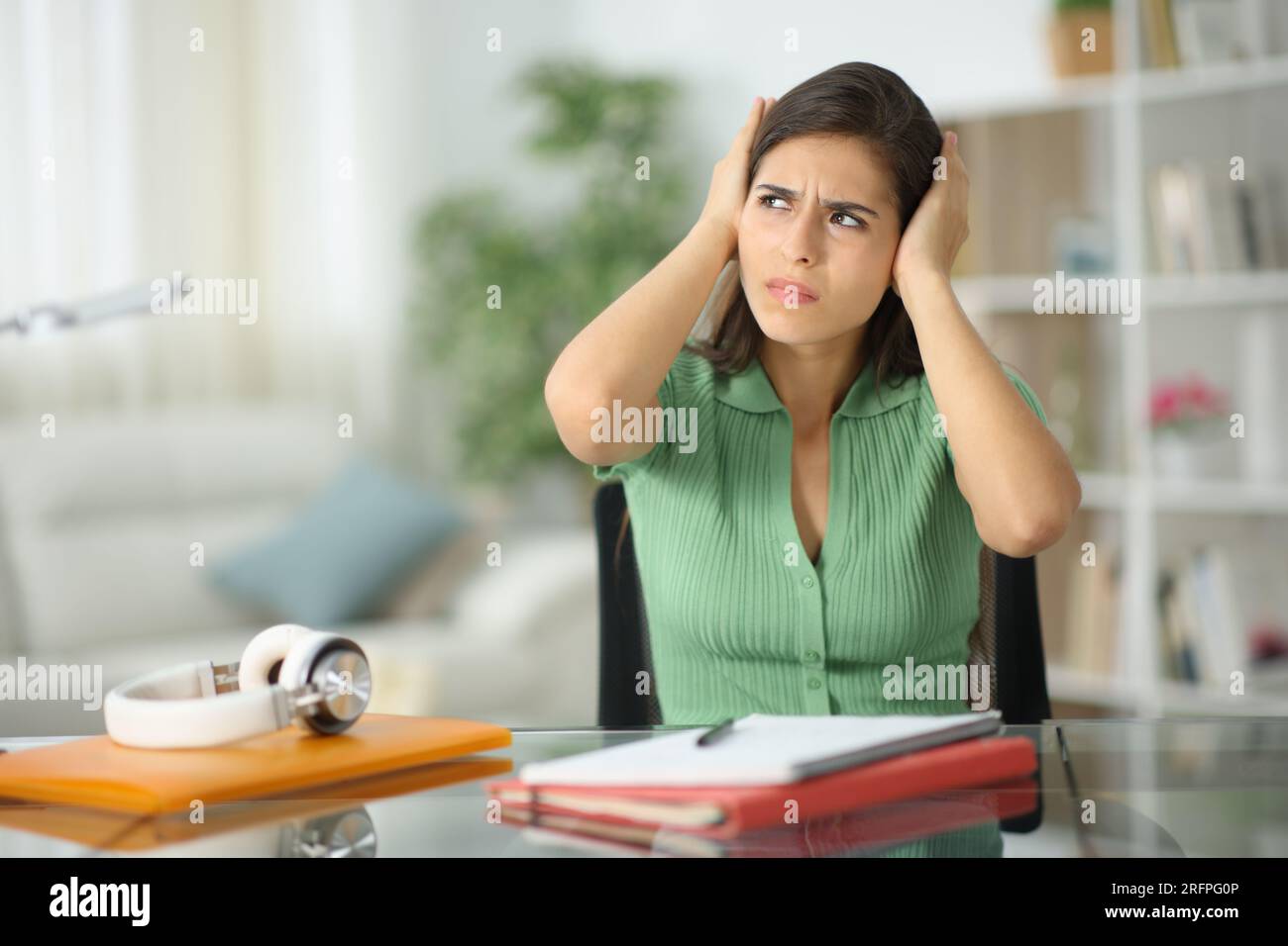 Stressed student complaining about neighbor noise at home Stock Photo