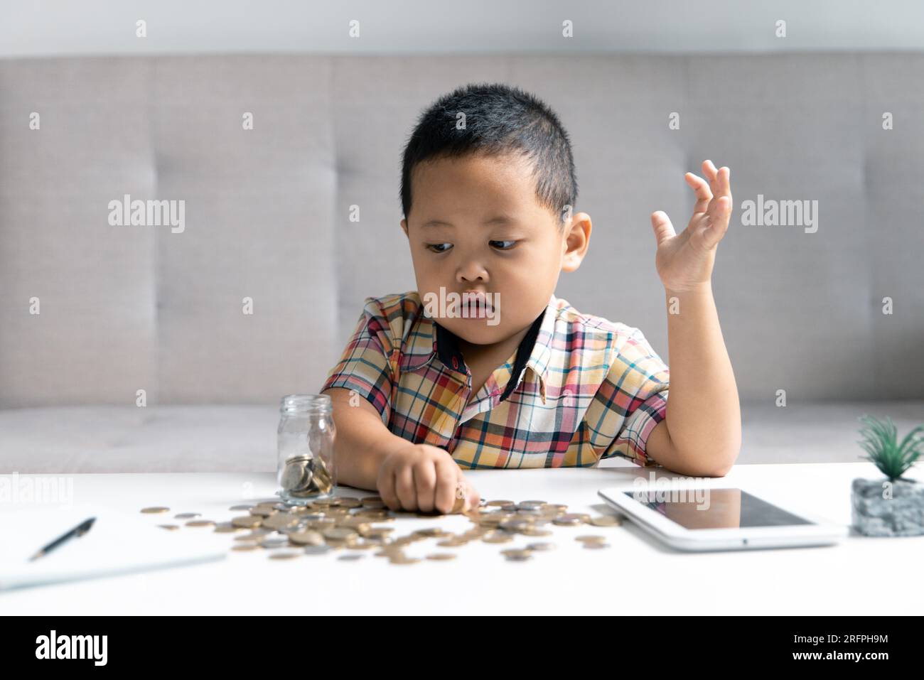Preschooler child learning to calculate personal budget, manage finance