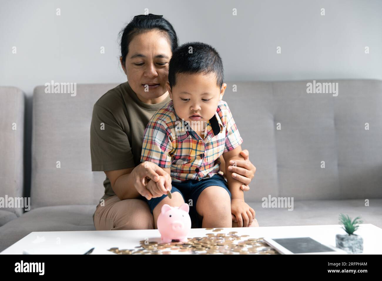 Excited baby boy playing with thermostat of heater Stock Photo - Alamy