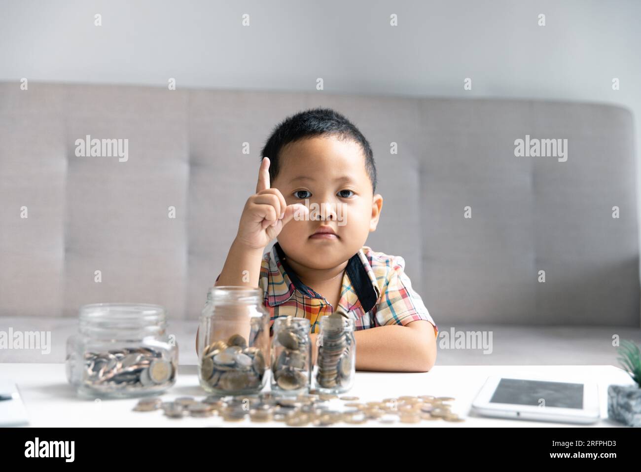 Preschooler child learning to calculate personal budget, manage finance