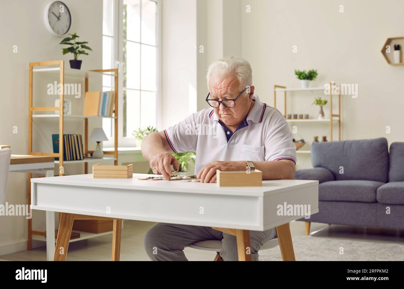 Senior retired man playing puzzle games to prevent dementia and