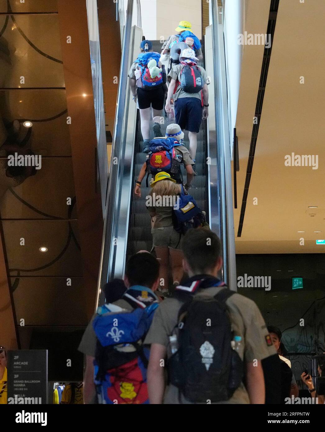 British scout members ride an escalator as they arrive from the World