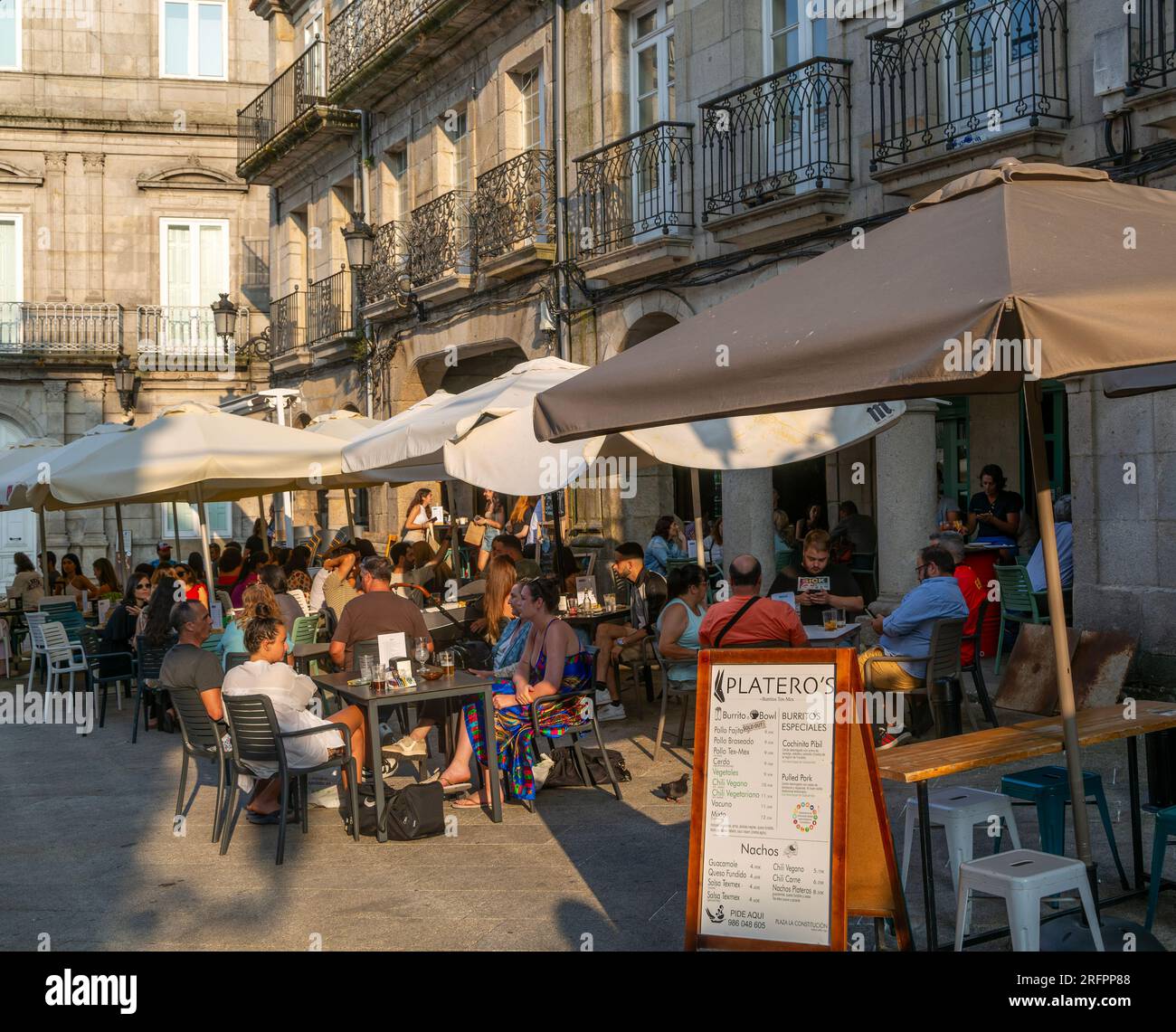 People and street cafes bars, near Plaza de la Constitucion square, old