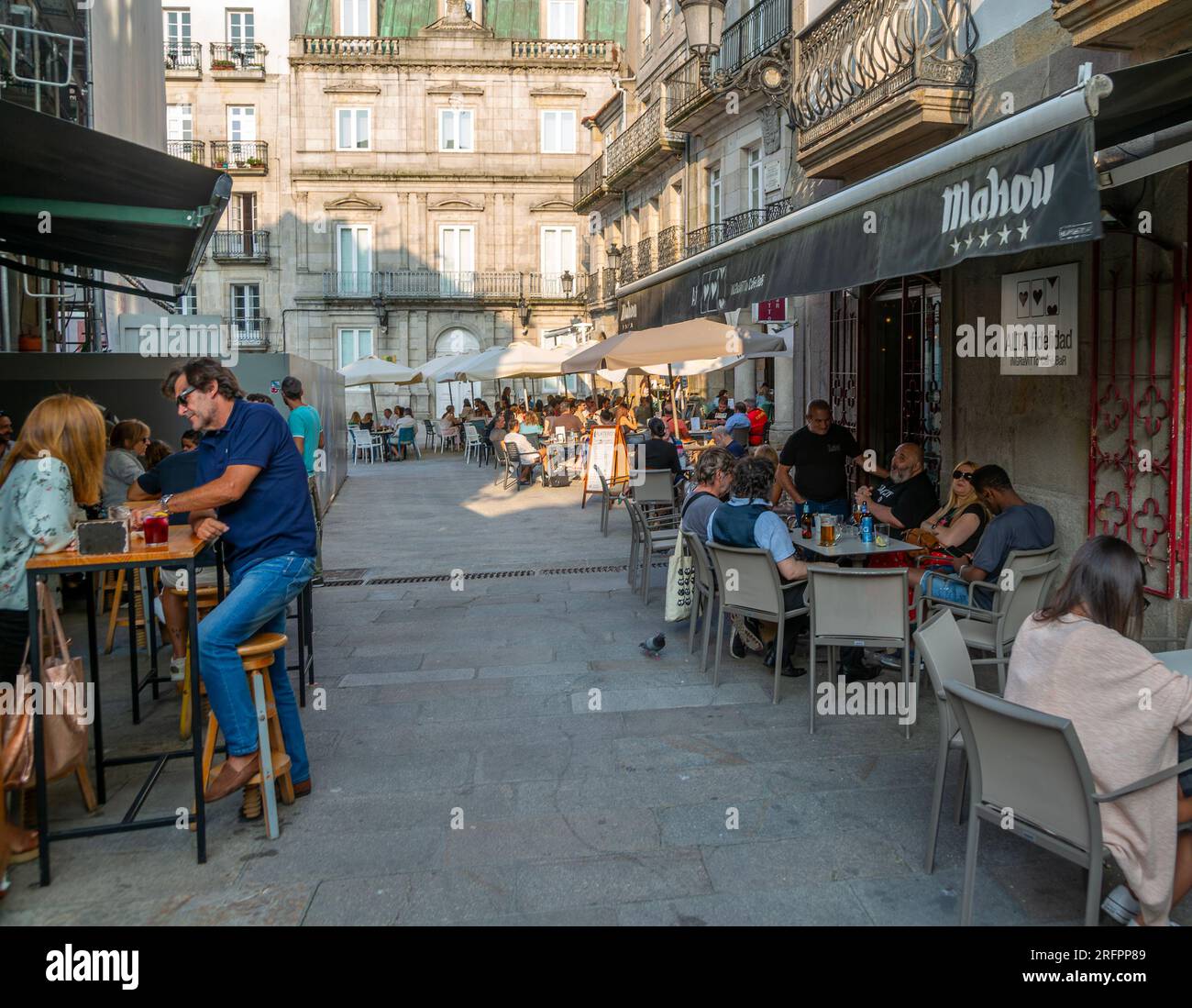 People and street cafes bars, near Plaza de la Constitucion square, old town city centre of Vigo, Galicia, Spain Stock Photo