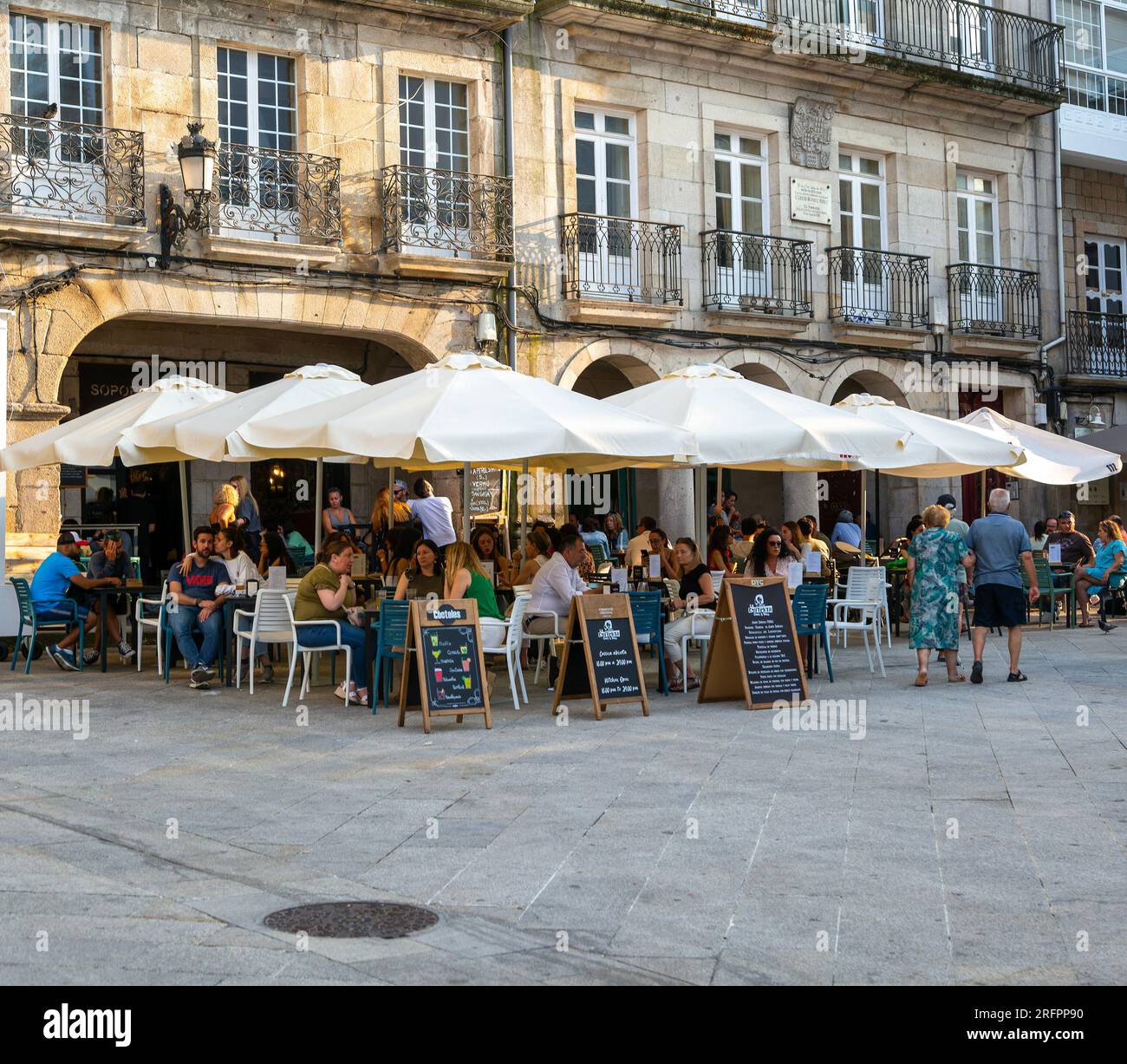 People and street cafes bars, near Plaza de la Constitucion square, old town city centre of Vigo, Galicia, Spain Stock Photo