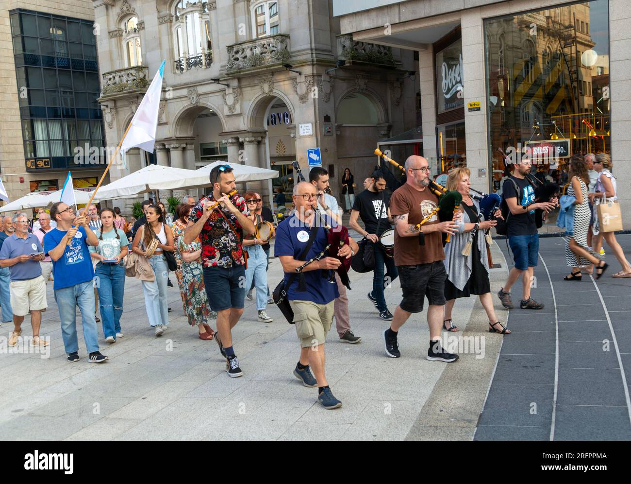 Bagpipe playing musicians BNG political party election campaign in plaza Praza Porto do Sol, city centre of Vigo, Galicia, Spain July 2023 Stock Photo