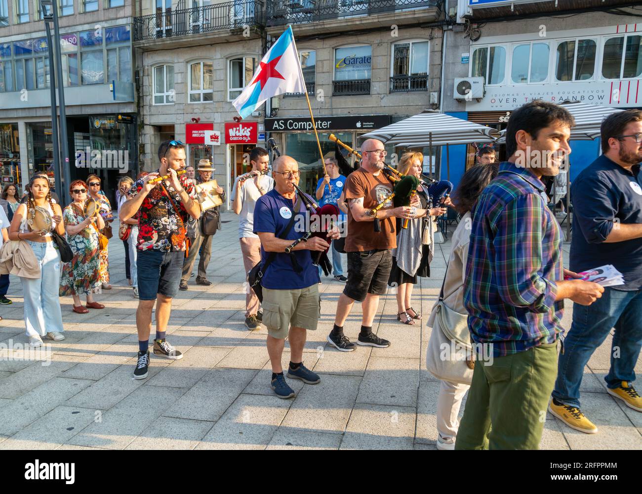 Bagpipe playing musicians BNG political party election campaign in plaza Praza Porto do Sol, city centre of Vigo, Galicia, Spain July 2023 Stock Photo