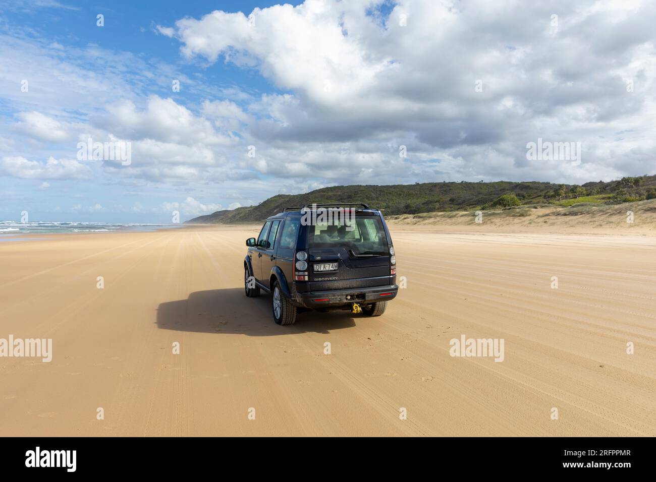 75 mile beach on Fraser Island K'gari, Land Rover Discovery 2016 model driving along sand highway, property released, Queensland,Australia Stock Photo
