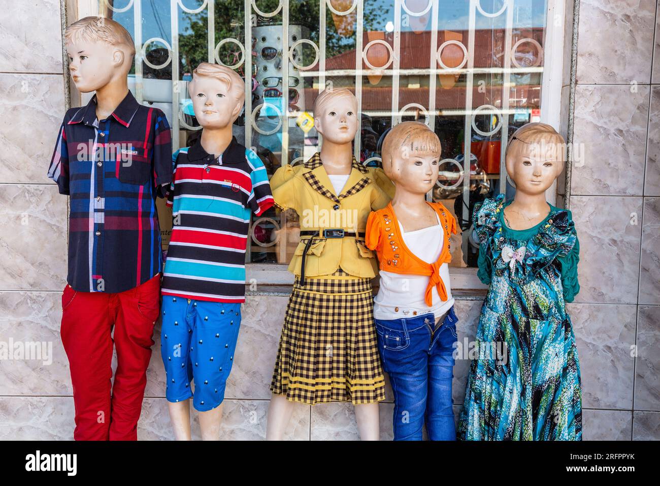 A line of mannequins representing children at the front of a fashion store in Jinja, Uganda. Stock Photo