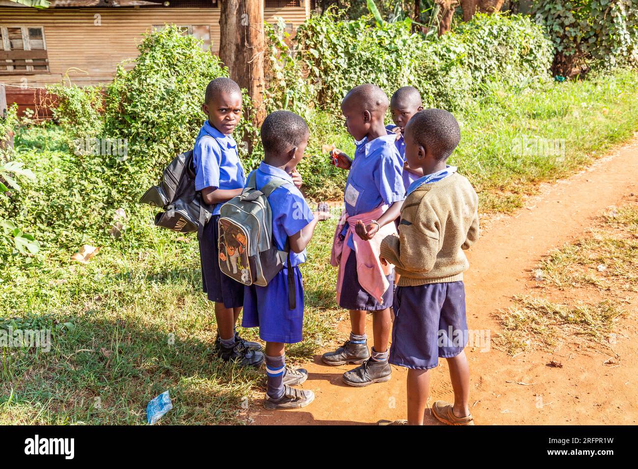Schoolchildren in conversation on the way home. Jinja, Uganda. Stock Photo